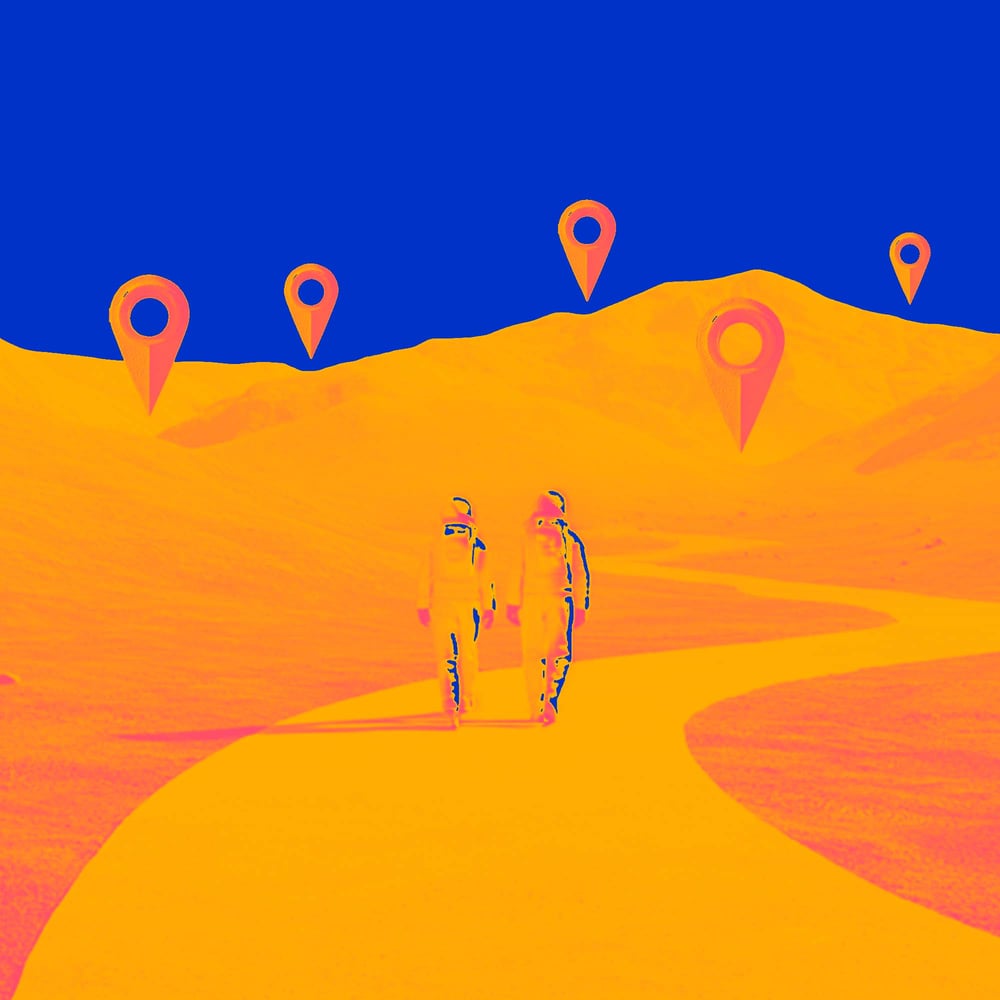 two people walking to tracker markers in hills