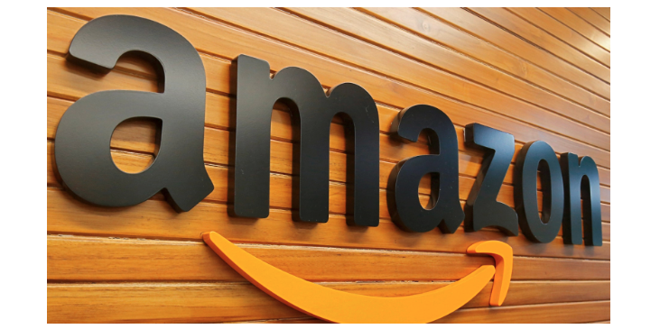 the word amazon in black letters hanging on a wooden wall with an orange arrow underneath