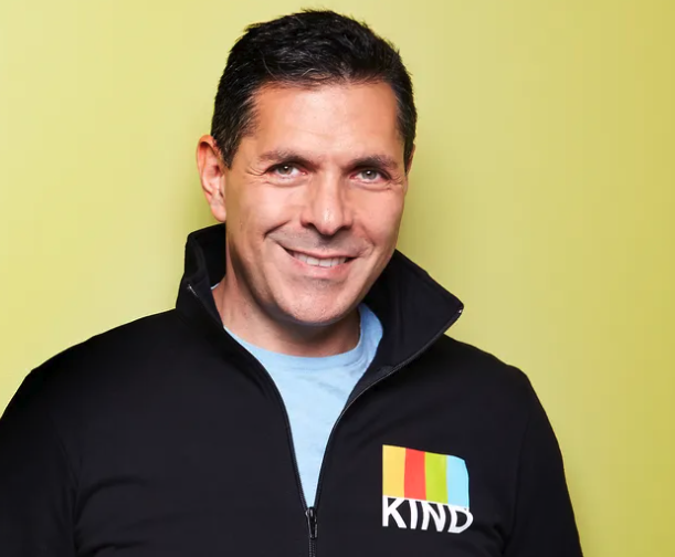 Photograph of Kind Snack founder Daniel Lubetzky in front of lime green background 