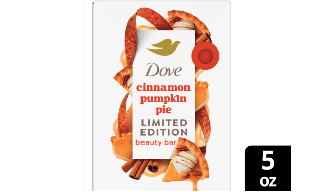 Dove soap bar package labeled ‘cinnamon pumpkin pie’ surrounded by slices of pumpkin pie, cinnamon sticks and orange streamers