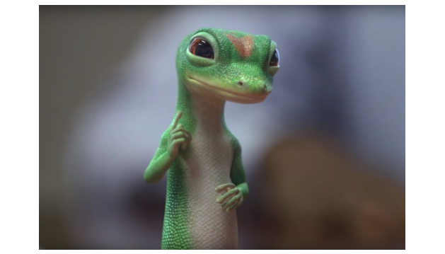 an image of the Geico Gecko holding up one finger, with a gray, blurry background