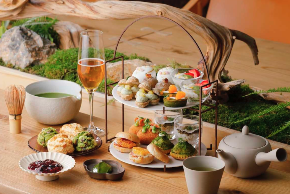 Green-tea based afternoon tea sits on cake stand alongside matcha and champagne. 