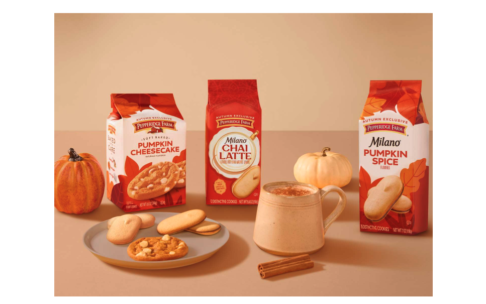 Milano chai latte cookie package alongside Milano's pumpkin flavored cookies surrounded by pumpkins and cinnamon