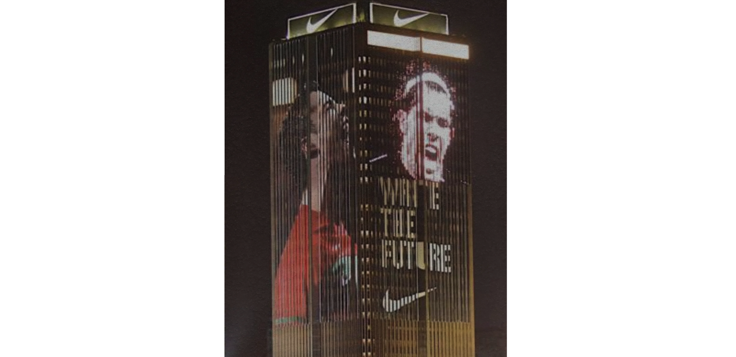 LED screen on Johannesburg building shows Nike logo and footballers. 