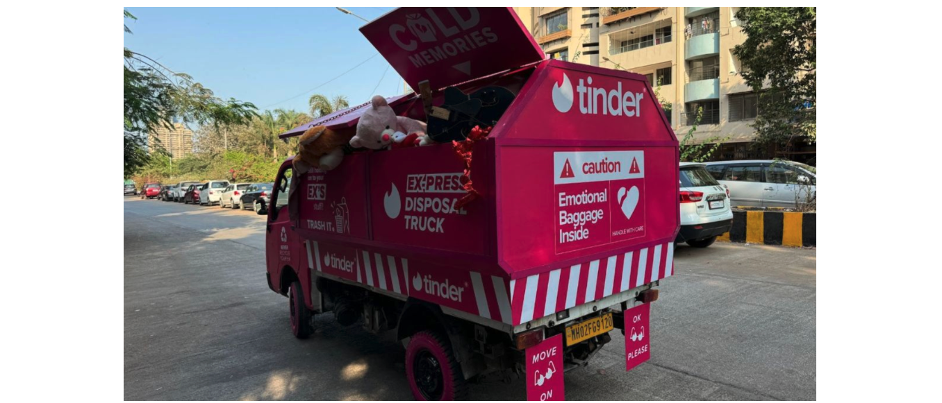 Pink disposal truck with Tinder branding