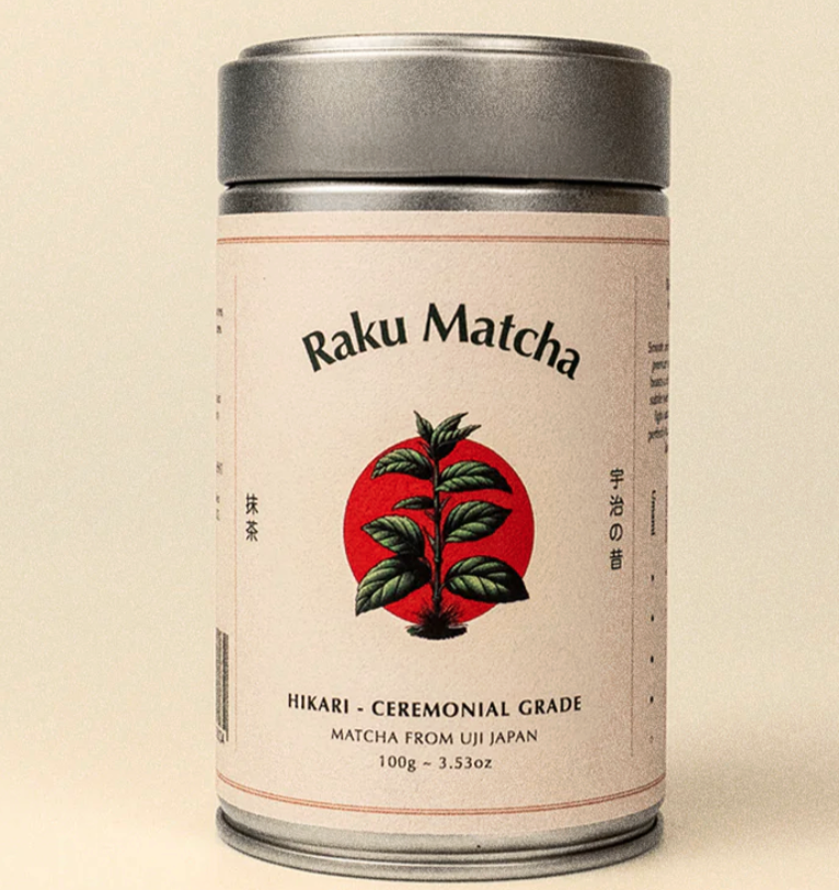 Tin of ceremonial grade matcha features a drawing of green tea leaf overlaid on a red circle. 