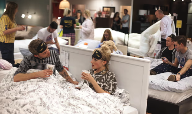 Photo from one of IKEA’s in store sleepovers showing people preparing to stay for the night inside the store 