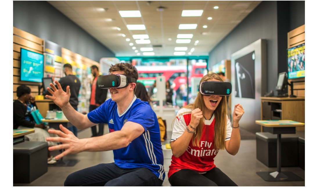Man in blue shirt and woman in red use VR headsets