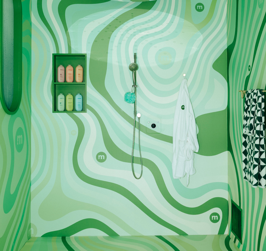 “Groovy-patterned” green shower cubicle is stocked with Method products. 