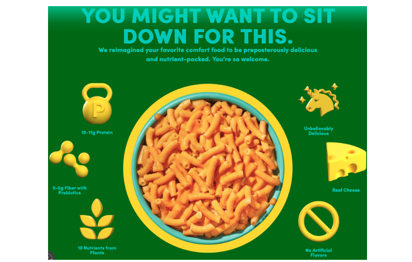 A green background with a bowl of mac and cheese. Across the top it says “you might want to sit down for this. We reimagined your favorite comfort food to be preposterously delicious and nutrient-packed. You’re so welcome.” 