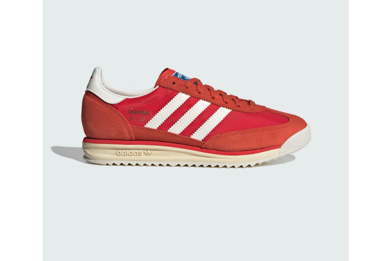 A photo of a red Adidas sneaker, with three white stripes running from the laces to the bottom